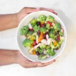 Be Meatless - World Vegetarian Day - photo of hands holding a salad bowl